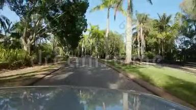 <strong>驶过</strong>热带棕榈树两旁的道路，划分高尔夫球场